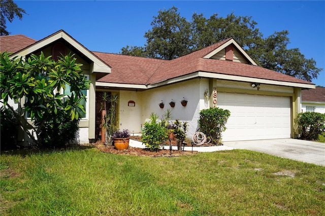 ranch-style house with a garage, concrete driveway, roof with shingles, stucco siding, and a front yard