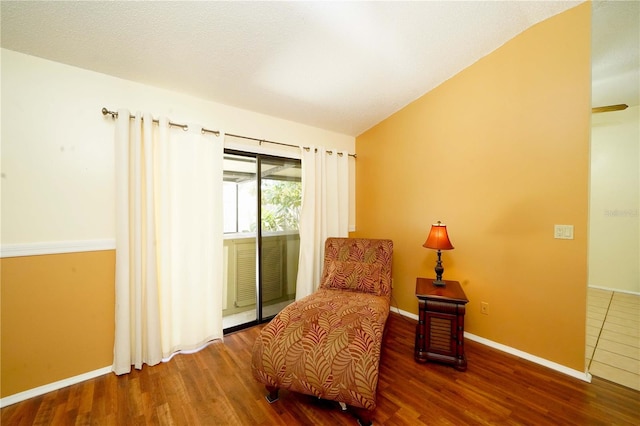 sitting room with vaulted ceiling and dark hardwood / wood-style floors