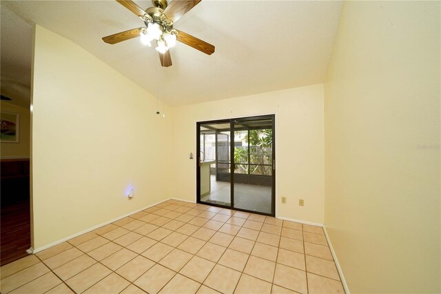 tiled empty room with ceiling fan and vaulted ceiling