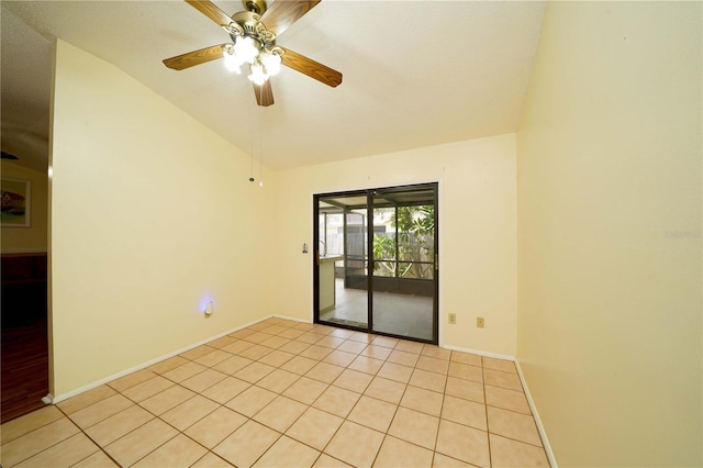 empty room featuring light tile patterned floors, ceiling fan, lofted ceiling, and baseboards