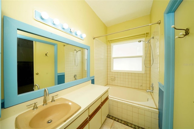 bathroom with tiled shower / bath, tile patterned flooring, and vanity