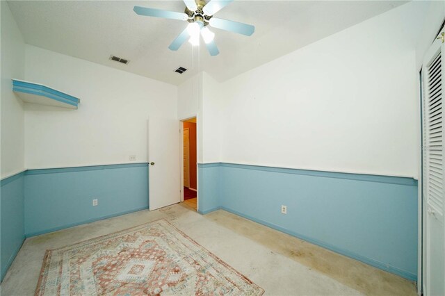 spare room with ceiling fan and light carpet