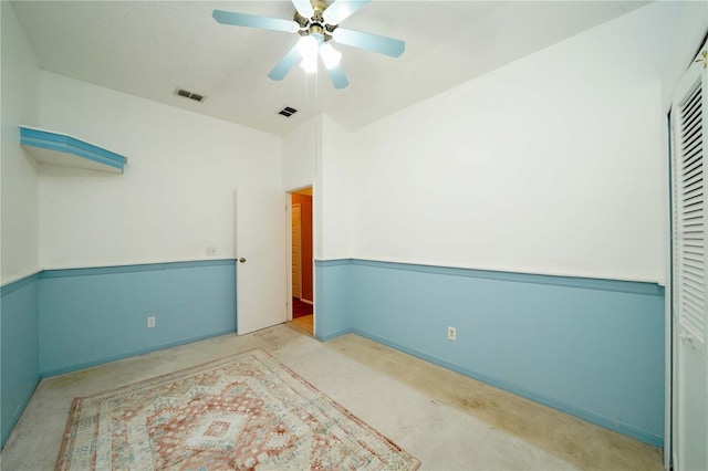 spare room featuring visible vents and a ceiling fan