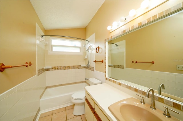 bathroom featuring toilet, tile patterned floors, a textured ceiling, tile walls, and shower / bathing tub combination