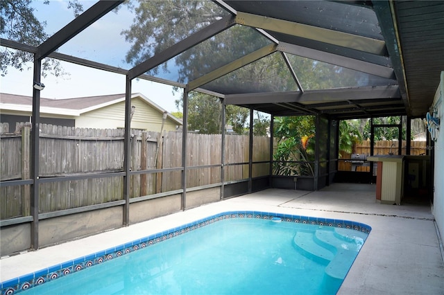 view of pool with a patio area and a lanai