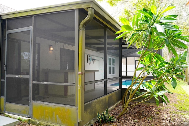 view of side of property with an outdoor pool