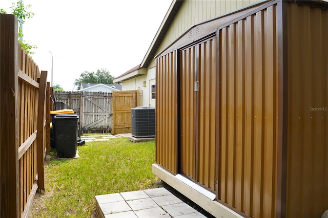 view of yard with a gate, fence, and cooling unit