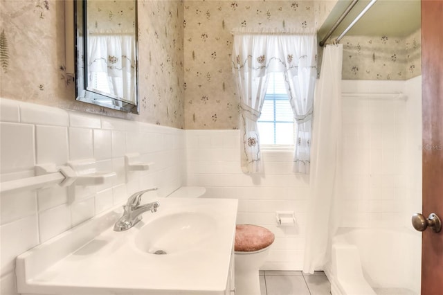 full bathroom featuring tile patterned flooring, tile walls, toilet, and vanity