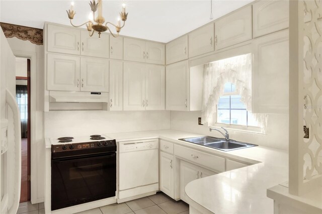 kitchen featuring sink, light tile patterned floors, white appliances, and a chandelier