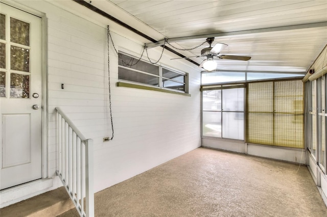 unfurnished sunroom with ceiling fan and lofted ceiling