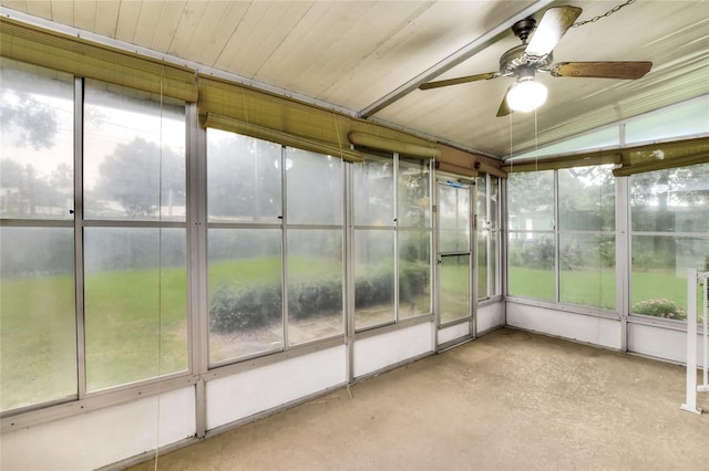 unfurnished sunroom featuring ceiling fan, vaulted ceiling, and a healthy amount of sunlight