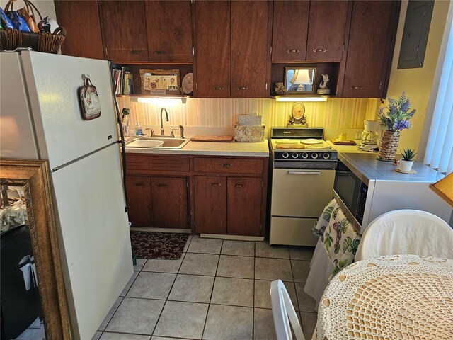 kitchen featuring light tile patterned floors, sink, white appliances, and electric panel