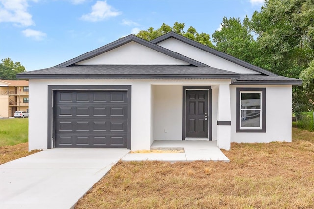 view of front of house with a garage and a front lawn