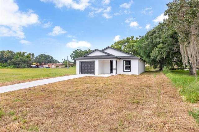 view of front facade with a front lawn and a garage