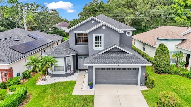 front facade featuring a garage and a front yard