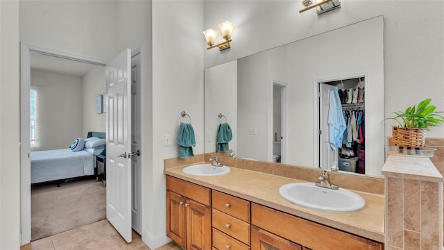 full bath featuring tile patterned flooring, ensuite bathroom, and double vanity