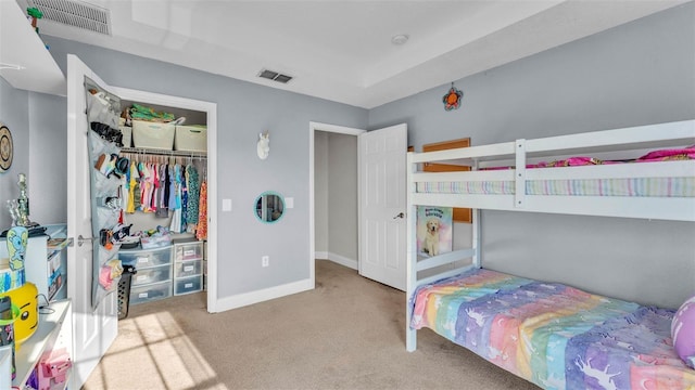 carpeted bedroom featuring baseboards and a closet