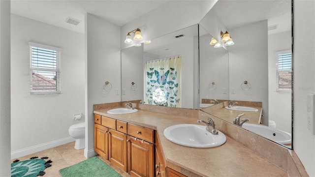 bathroom featuring toilet, plenty of natural light, and tile patterned flooring