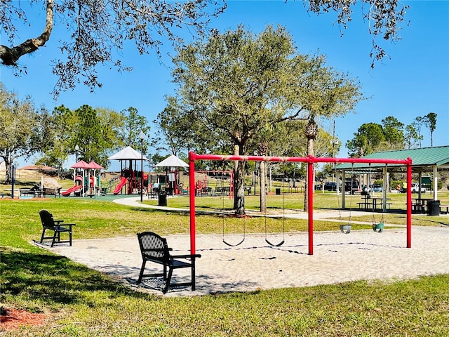 view of property's community featuring a playground and a lawn