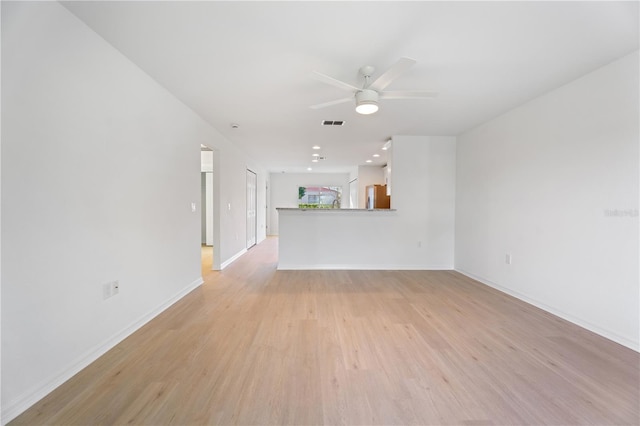 unfurnished living room featuring ceiling fan and light hardwood / wood-style floors