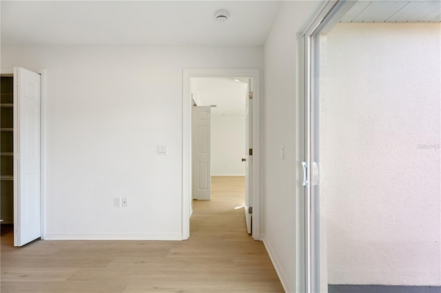 hallway with light hardwood / wood-style flooring