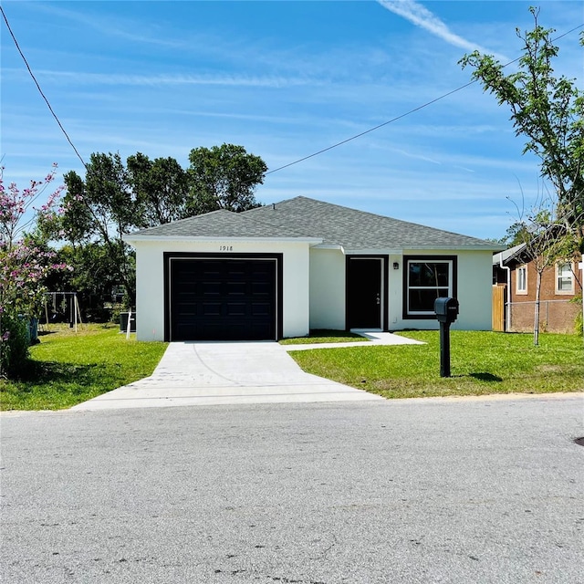 1918 Dr Martin L King Jr Way, Haines City, FL 33844 - view of front of home with a garage, concrete driveway, stucco siding, and a shingled roof