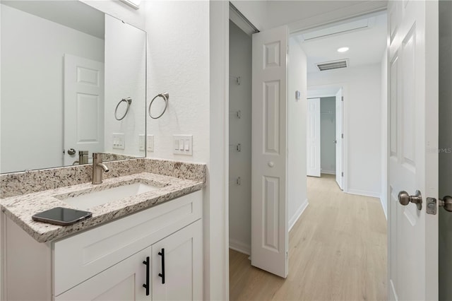 1918 Dr Martin L King Jr Way, Haines City, FL 33844 - bathroom featuring wood finished floors, vanity, and baseboards