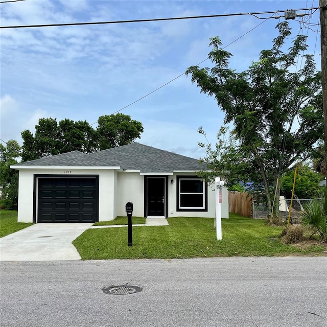 1918 Dr Martin L King Jr Way, Haines City, FL 33844 - view of front of house featuring driveway, an attached garage, a shingled roof, and stucco siding