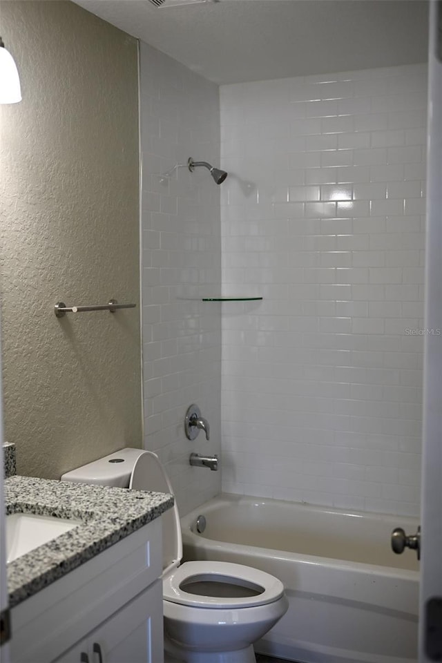 full bathroom with vanity, toilet, and tiled shower / bath