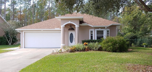 view of front of house featuring a garage and a front lawn