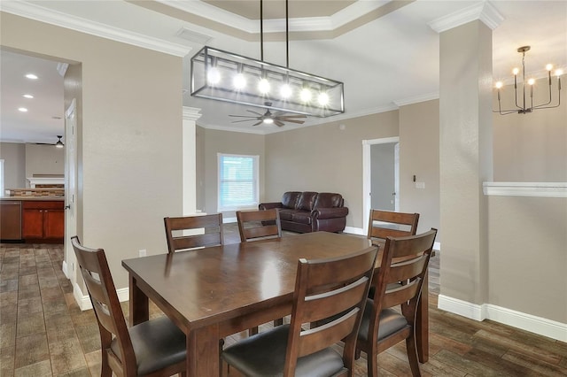 dining space with crown molding, ceiling fan with notable chandelier, and dark hardwood / wood-style floors