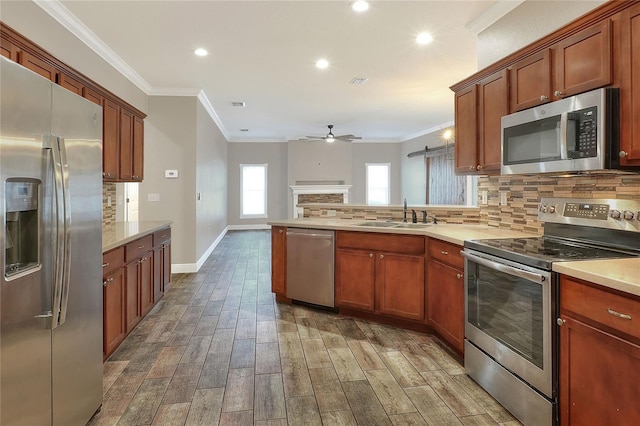 kitchen featuring crown molding, sink, stainless steel appliances, and hardwood / wood-style flooring