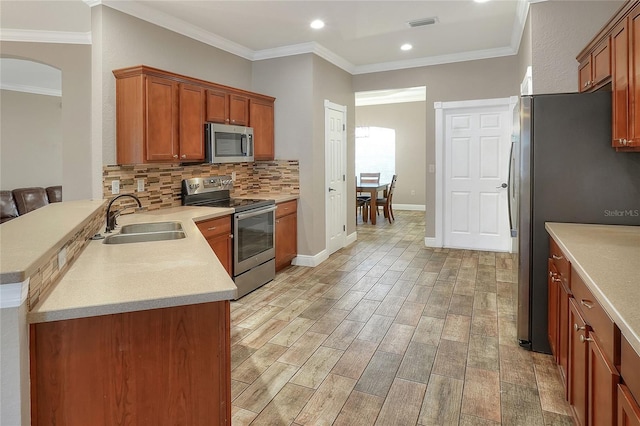 kitchen with kitchen peninsula, stainless steel appliances, light hardwood / wood-style flooring, and sink