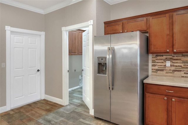 kitchen with tasteful backsplash, stainless steel fridge with ice dispenser, hardwood / wood-style floors, and ornamental molding