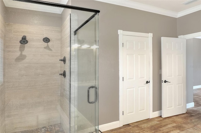 bathroom featuring hardwood / wood-style flooring, ornamental molding, and walk in shower