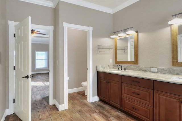 bathroom featuring hardwood / wood-style floors, toilet, and ornamental molding