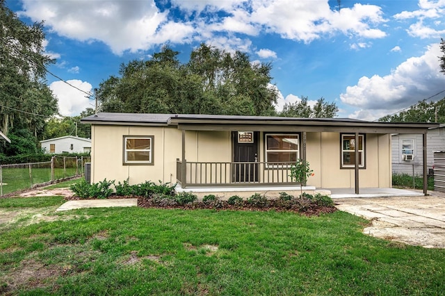 ranch-style home featuring a porch, a front yard, fence, and stucco siding