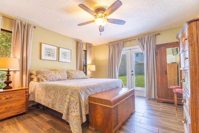 bedroom with a textured ceiling, dark hardwood / wood-style flooring, french doors, access to exterior, and ceiling fan