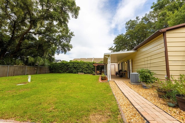 view of yard featuring central AC unit and a patio