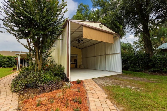 view of outbuilding with a yard and a carport