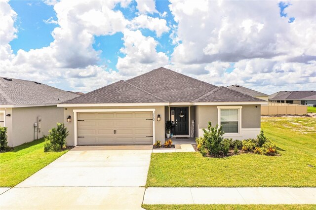 ranch-style house featuring a garage and a front yard