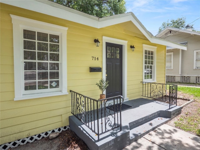 view of exterior entry featuring a porch