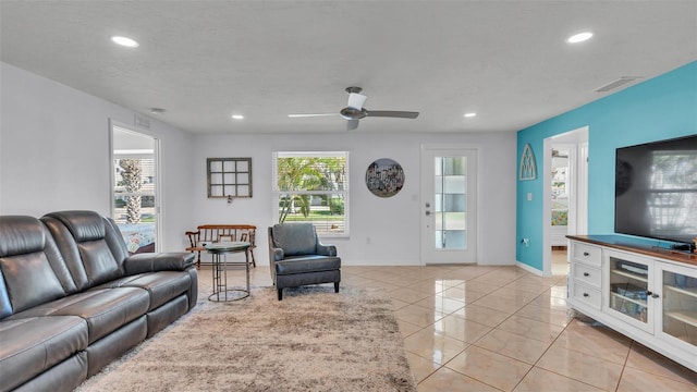 tiled living room featuring a textured ceiling and ceiling fan