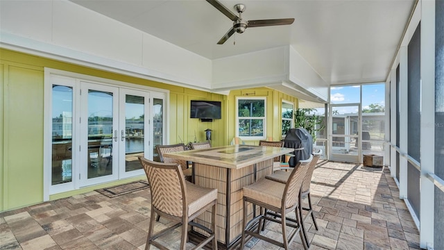 sunroom with ceiling fan and french doors