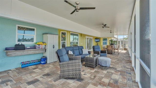 sunroom featuring plenty of natural light and ceiling fan