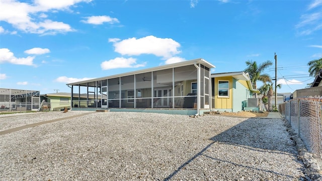 view of front of home with a sunroom and a carport