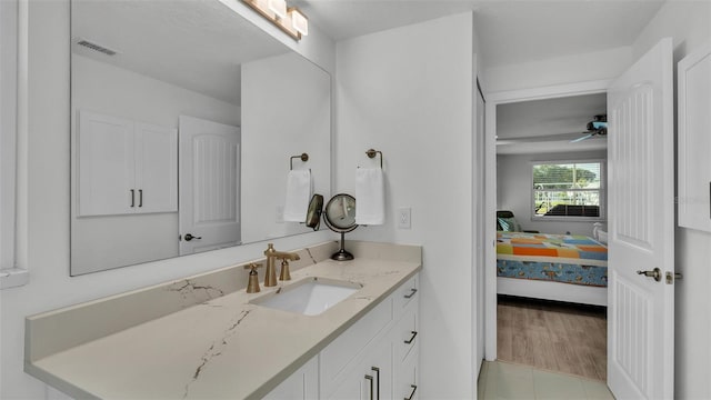 bathroom featuring ceiling fan, hardwood / wood-style flooring, and vanity