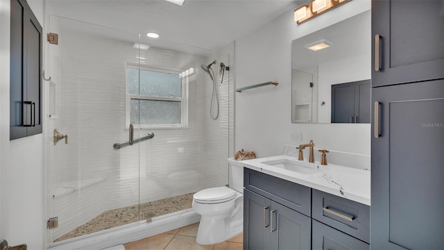 bathroom featuring vanity, toilet, a shower with shower door, and tile patterned flooring