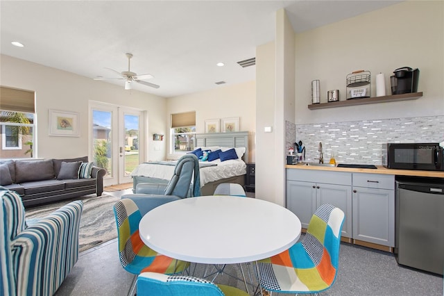 living room featuring french doors, ceiling fan, and sink