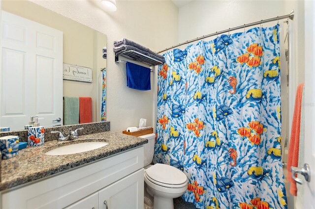 bathroom with vanity, toilet, and a shower with shower curtain